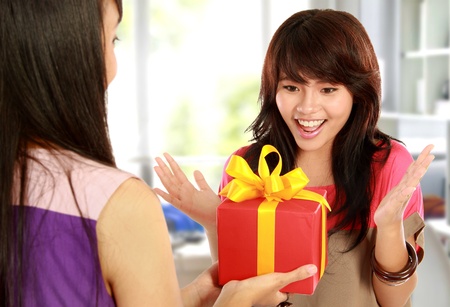 portrait of young woman having surprise presentの写真素材