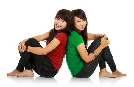 portrait of attractive two girls smiling to the camera on white backgroundの写真素材