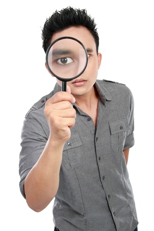 portrait of young man looking through a magnifying glass isolated over white background portrait of young man looking through a magnifying glass isolated over white background
