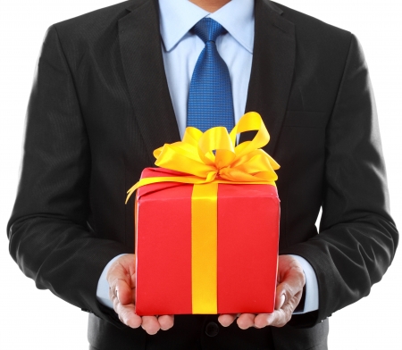 Businessman present gift box, isolated over white background.の写真素材