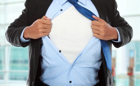 Businessman showing a superhero suit underneath his suit in the officeの写真素材