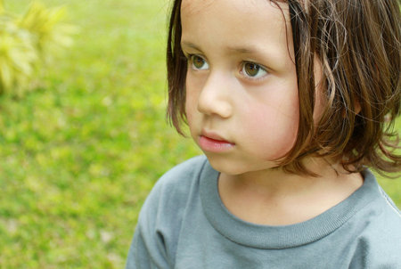close up Portrait of little boy in summer day at the parkの写真素材