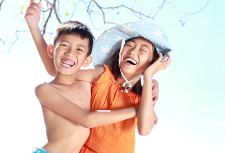 Portrait of happy asian kids having fun in beautiful sunny dayの写真素材