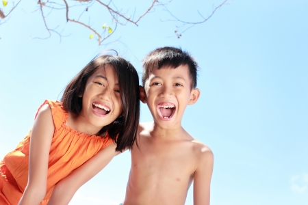 Portrait of happy asian kids having fun in beautiful sunny dayの写真素材