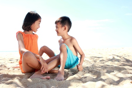 Portrait of happy kids in the summer on the sandの写真素材