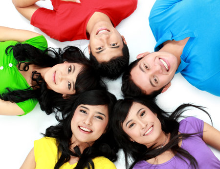 happy group of friends smiling with their heads together on the floor