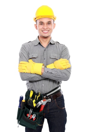 smiling worker crossed his arms and bring equipment ready to workの写真素材