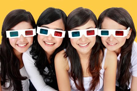 portrait of four woman wearing 3d glassesの写真素材