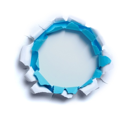 Hole ripped in white and blue paper on light blue backgroundの写真素材