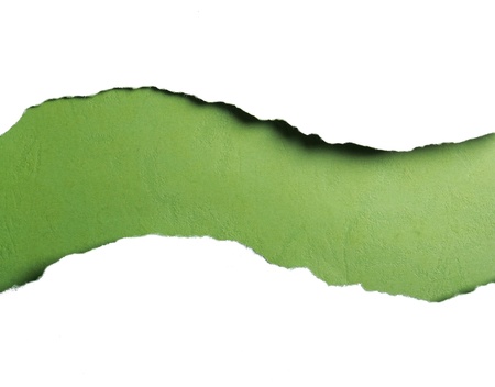 ripped white paper over green color backgroundの写真素材