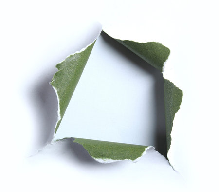 white with green torn paper with square shape over light blue backgroundの写真素材