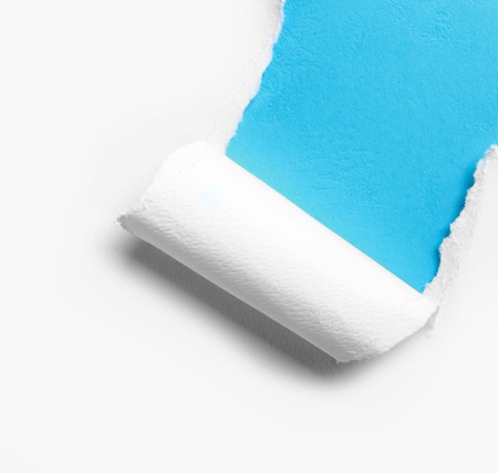 corner white torn paper with blue background, ready for your designの写真素材