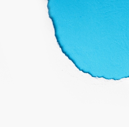 corner white torn paper with blue background, ready for your designの写真素材