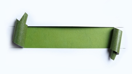 ripped white paper over green color backgroundの写真素材