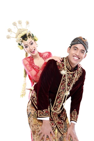 Happy traditional java wedding couple husband and wife isolated on white backgroundの写真素材
