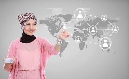 Attractive woman holding smartphone isolated on white background. working on touching screen.の写真素材