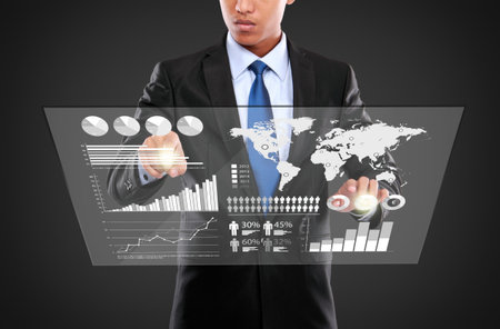 man pushing on a touch screen interface of infographics