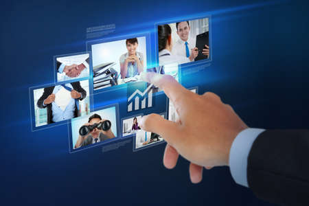 Finger pushing button on a touch screen interface over virtual backgroundの写真素材