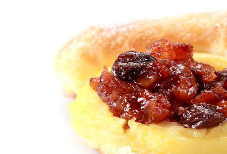 Fresh and tasty buns with raisins over white backgroundの写真素材