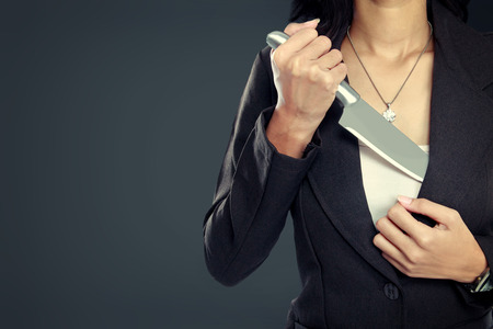 portrait of Business woman pull out his Knife. ready to attackの写真素材