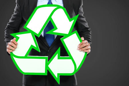 Portrait of businessman holding recycle sign iconの写真素材