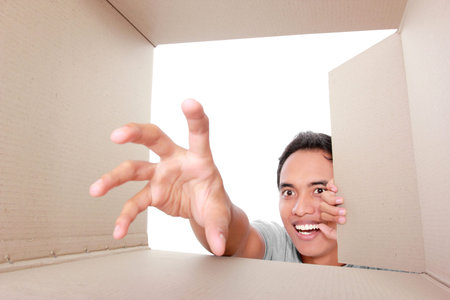 portrait of a man trying to take something inside the box