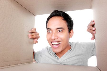 portrait of a man looking for something inside box