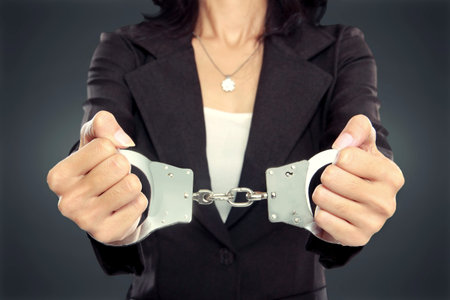 close up portrait of Young business woman in handcuffs. crime conceptの写真素材