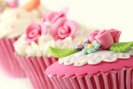 sweet cupcakes decorated with sugar paste and creamの写真素材