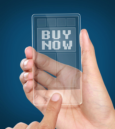 image of hands holding futuristic transparent mobile phone with buy now on the screenの写真素材
