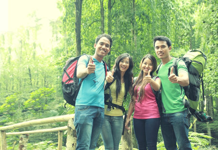 portrait group of friends on a hiking showing thumb up