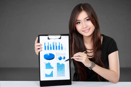 asian businesswoman presenting chart document in the officeの写真素材