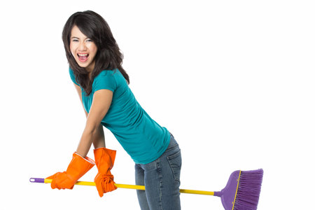 Cleaning girl happy excited during cleaning. Funny girl with cleaning mop playing. isolated on white backgroundの写真素材