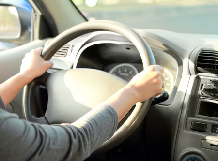 portrait of woman with her hand on the wheel steering