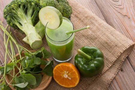 A potrait of a glass green paprika, broccoli, and spinach mix juiceの写真素材