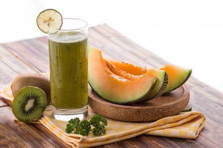 A potrait of a glass of Kiwi and melon smoothiesの写真素材