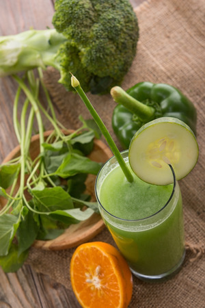 A potrait of a glass green paprika, broccoli, and spinach mix juiceの写真素材