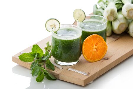 A potrait of mixing mint, orange, and pokchoy juiceの写真素材