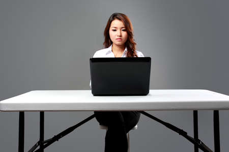 A portrait of a young businesswoman typing on laptopの写真素材
