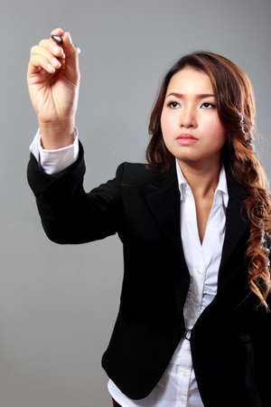 A portrait of a young businesswoman working on a virtual screenの写真素材
