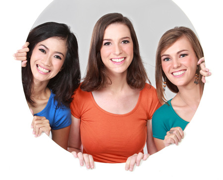 Portrait group of happy teenagers having fun hiding behind the circleの写真素材