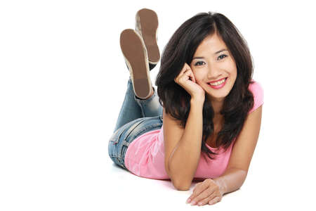 Beautiful smiling woman relaxing on the floor looking cameraの写真素材