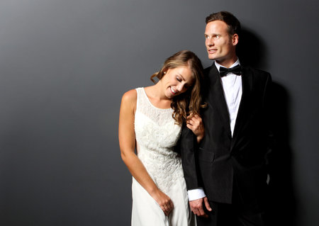 portrait of amazing young newlywed couple with dark backgroundの写真素材