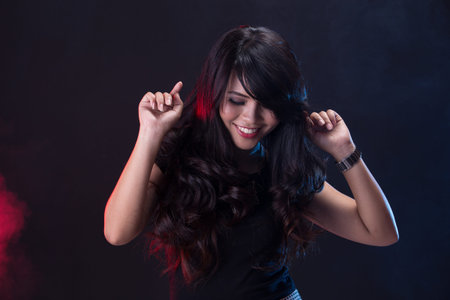 A portrait of young woman dancing on the disco party
