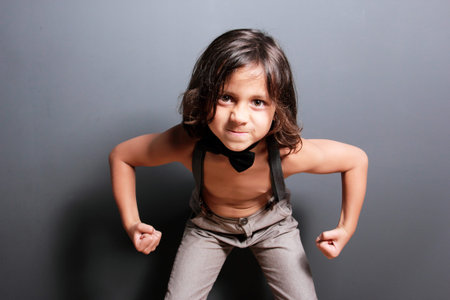 portrait of good looking boy with long hair feeling strong