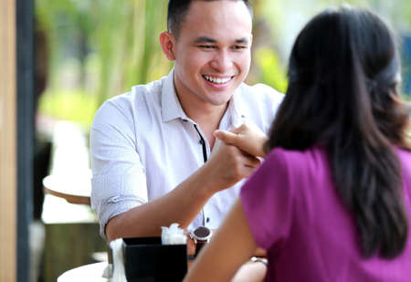 handsome man man smiling while holding his girlfriend handの写真素材