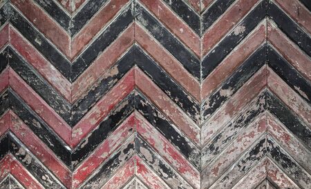 A portrait of rusty wooden gate door with a triangle pattern, brown and black colorの写真素材