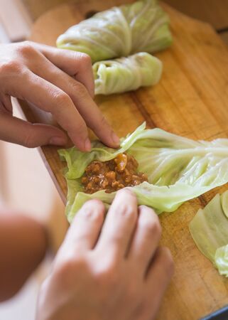 A portrait of processing to make a meat wrap in cabbage. cabbage roll recipeの写真素材