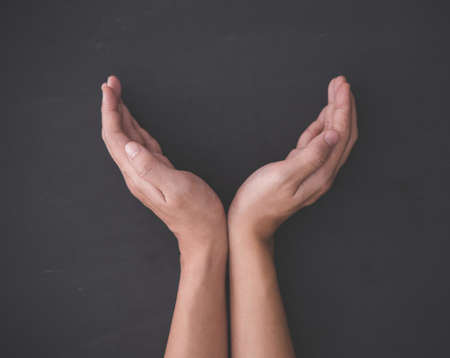 Hands making shape of try to protect/ catching something, hand gestureの写真素材