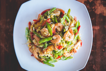 A portrait of stir-fry prawn with bean on square white plateの写真素材